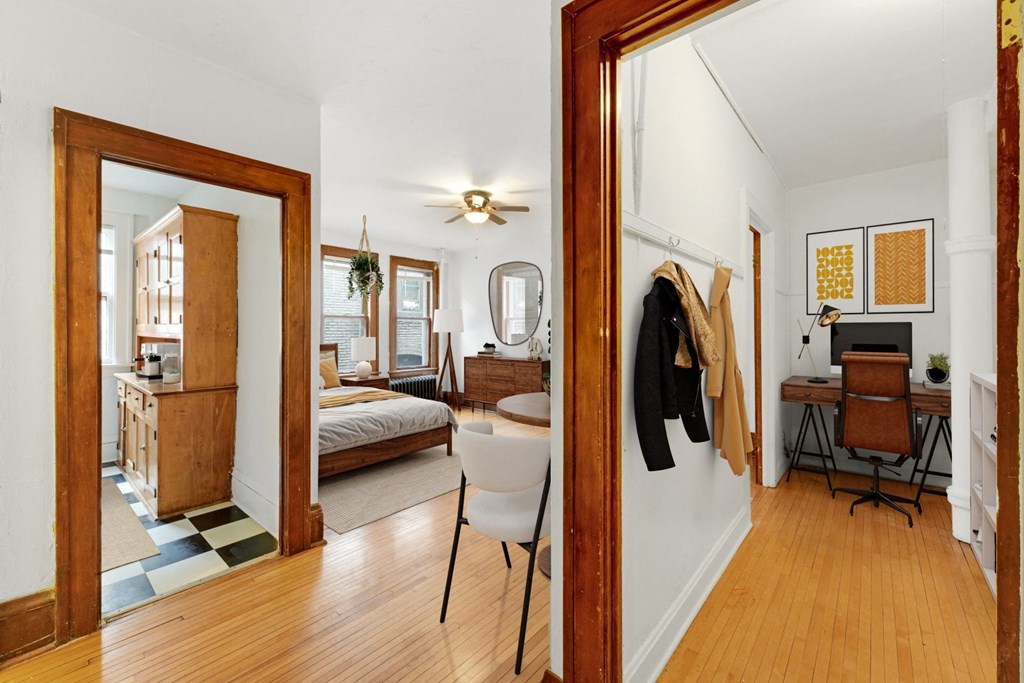 a living room with a mirror and a bedroom with a bed