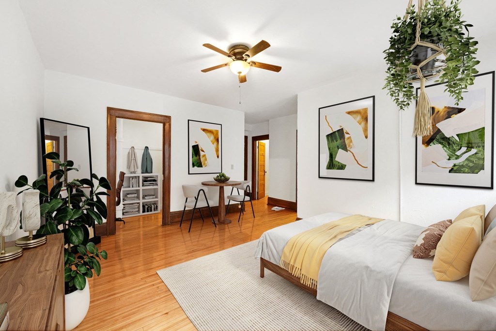 a bedroom with a bed and a ceiling fan