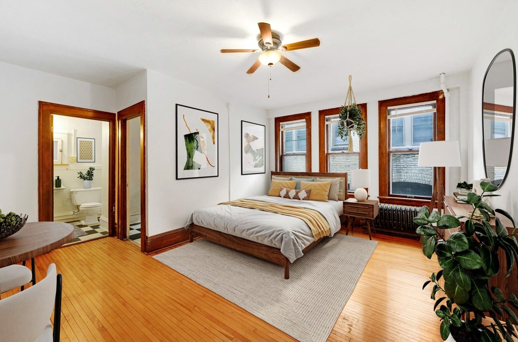 a bedroom with a bed and a ceiling fan