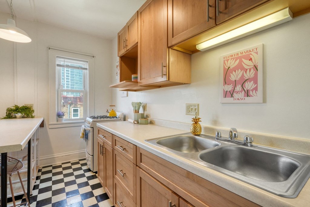 a kitchen with wooden cabinets and a checkered floor