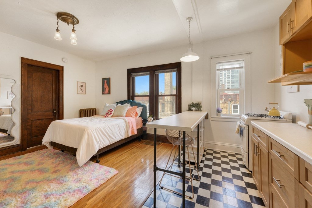 a bedroom with a bed and a desk with a chair