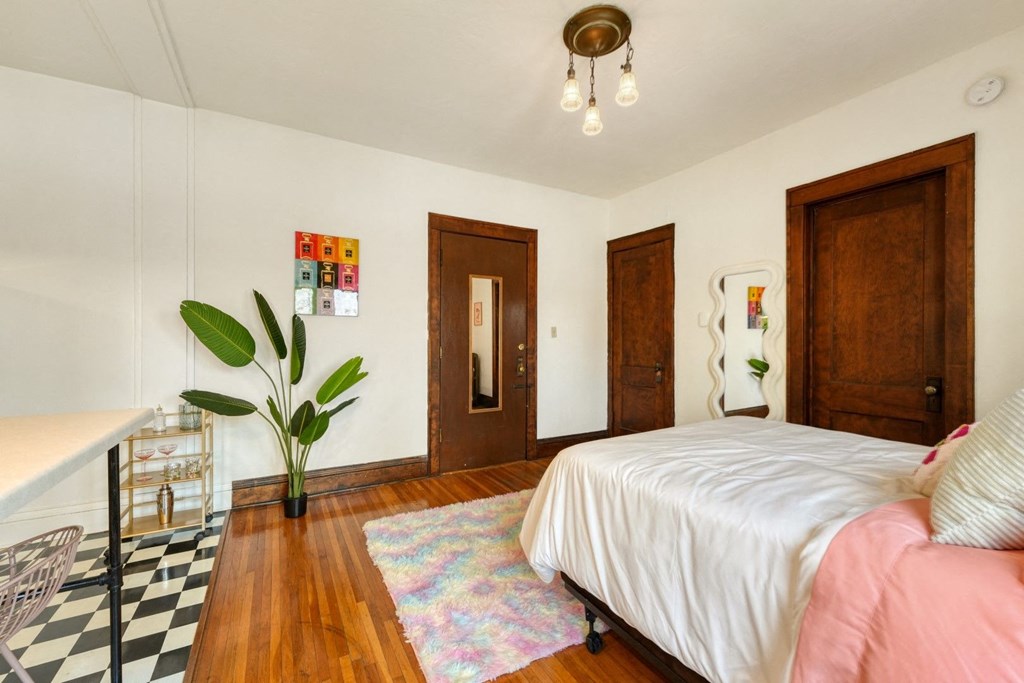 a bedroom with a bed and a desk