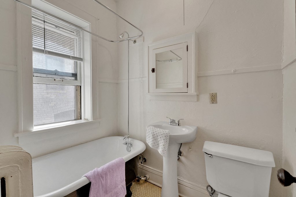 a small bathroom with a tub and sink