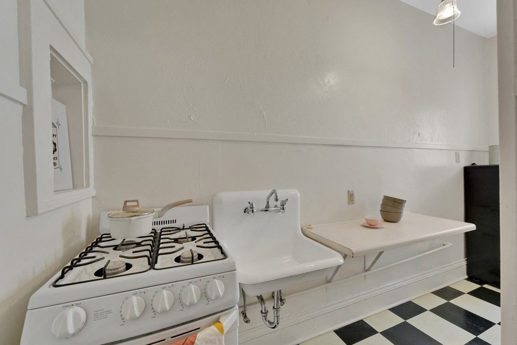 a kitchen with a stove and a sink