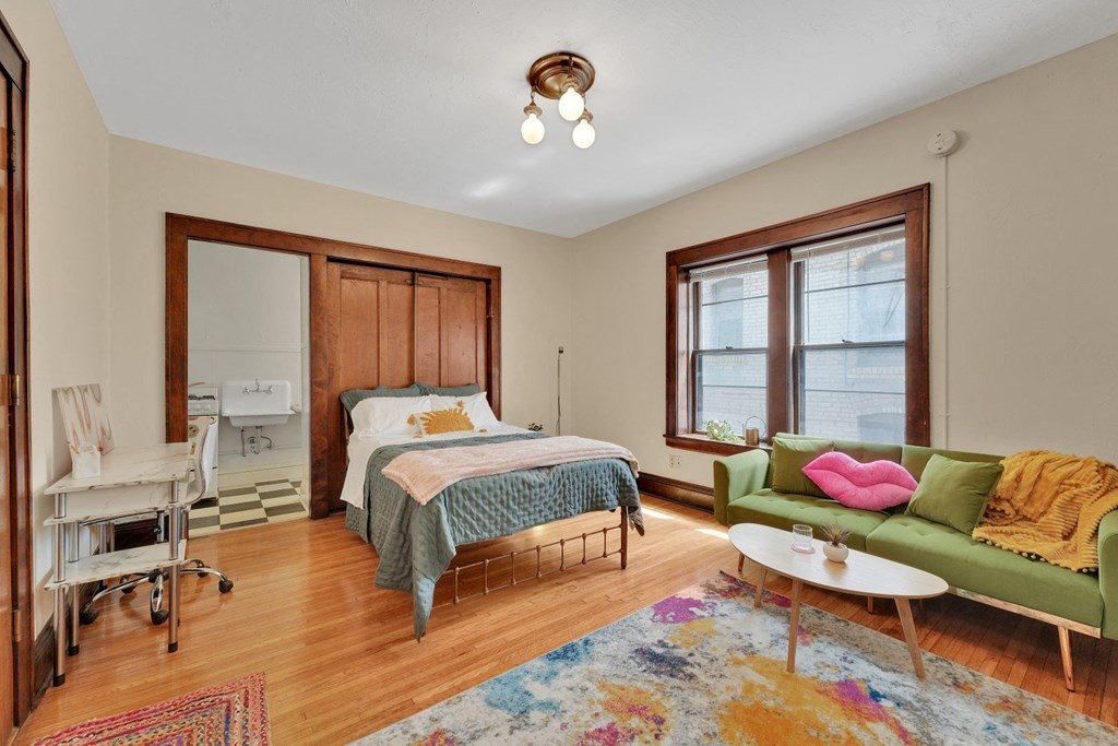 a bedroom with a bed and a couch