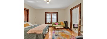 a bedroom with a bed and a couch