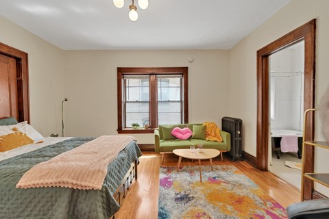 a bedroom with a bed and a couch