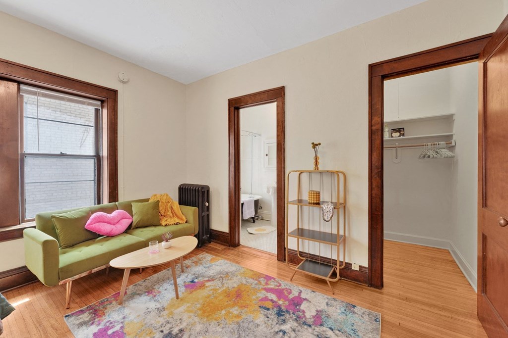 a living room with a green couch and a rug