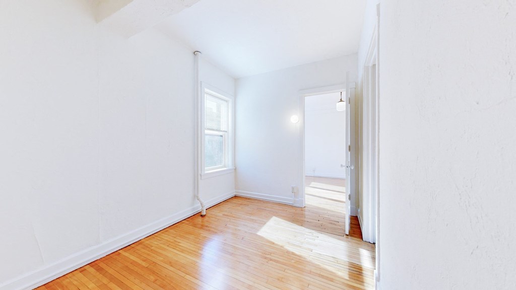 Spacious, Open Concept Bedroom with Restored Hardwood Flooring at The Park Apartments in Minneapolis, MN
