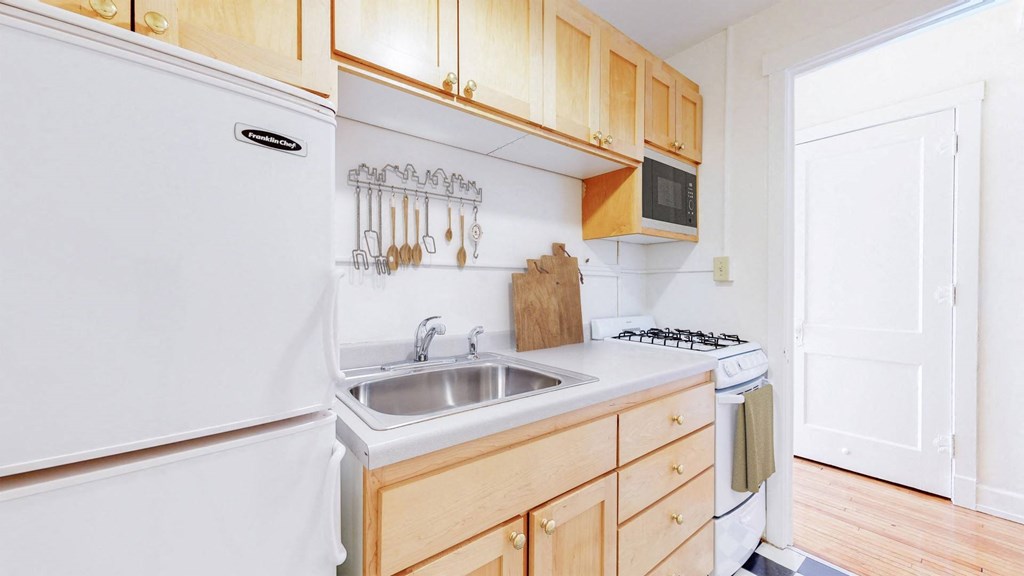 Cozy Kitchen With Natural Wood Cabinetry at The Park Apartments in Minneapolis, 55403