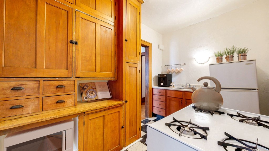 Kitchen with Wood Cabinetry and Vintage Style Decoration at The Park Apartments in Minneapolis, MN