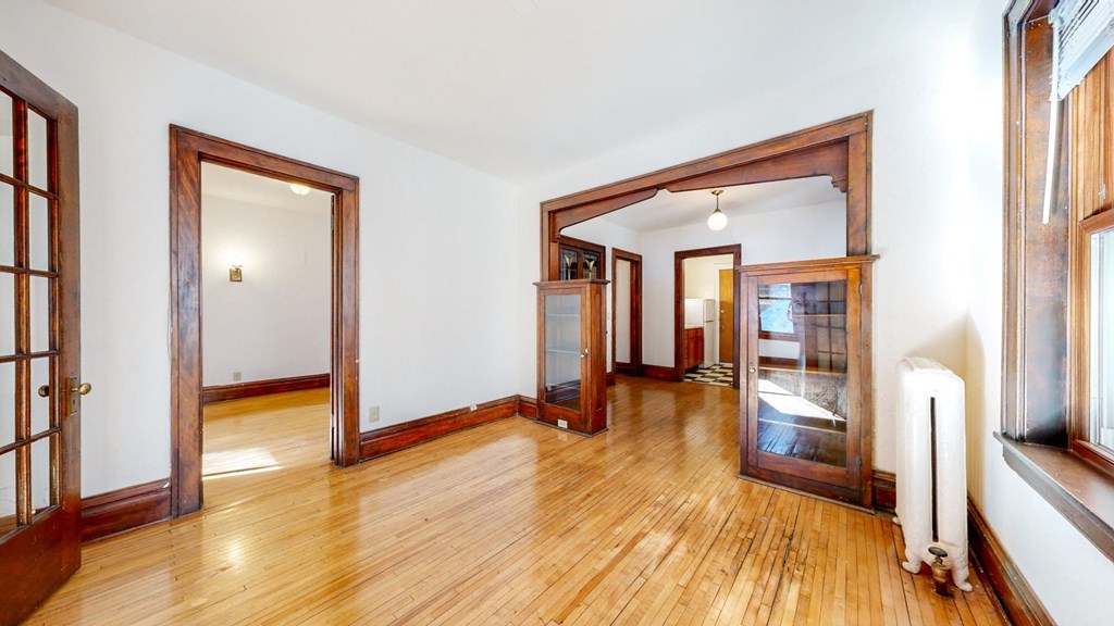 Stunning Apartment with Light Colored REsotred Hardwood Flooring and Contrasting Dark Wood Trim at The Park Apartments in MN 55403