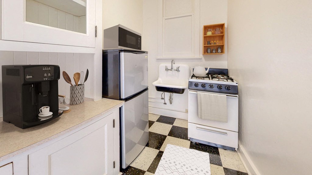 Retro Style Kitchen with Black and White Checkered Tile Flooring at The Park Apartments in Minnesota, 55403
