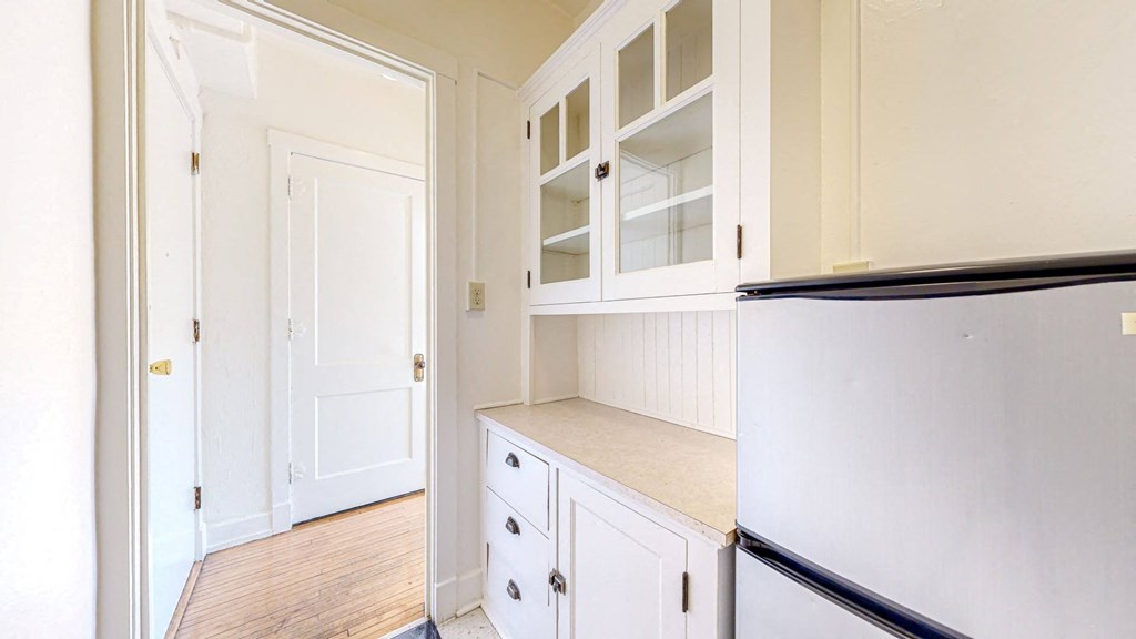 A Gorgeous Retro Kitchen with White Cabinetry and Restored Hardwood Flooring at The Park Apartments in Minneapolis, 55403