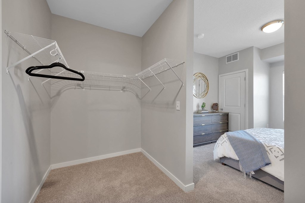a bedroom with a bed and a mirrored closet