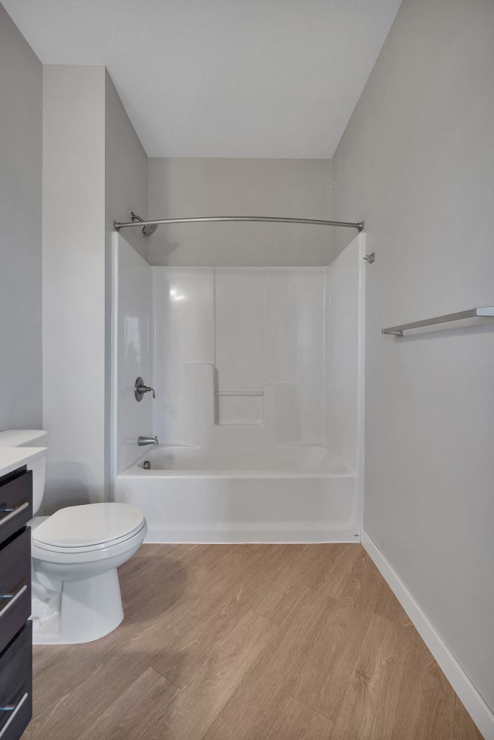 a bathroom with a toilet and a bath tub