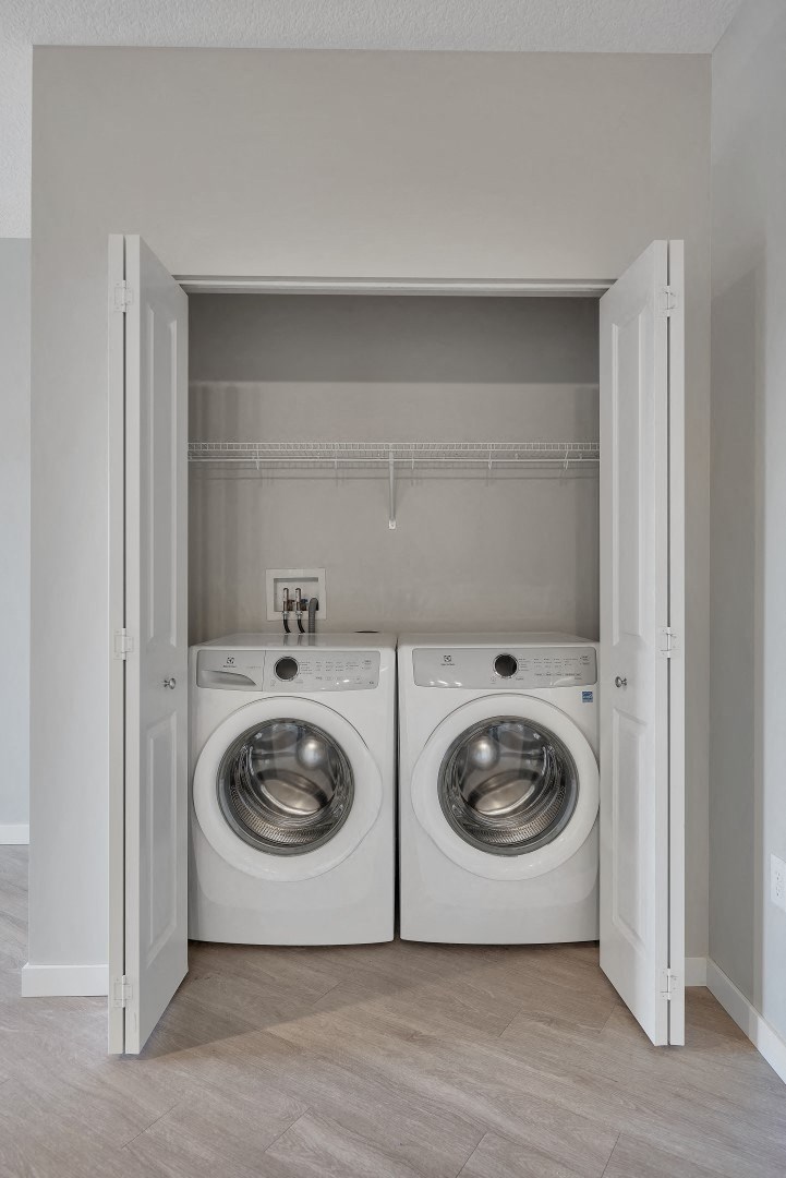 a washer and dryer in a laundry room with a door open