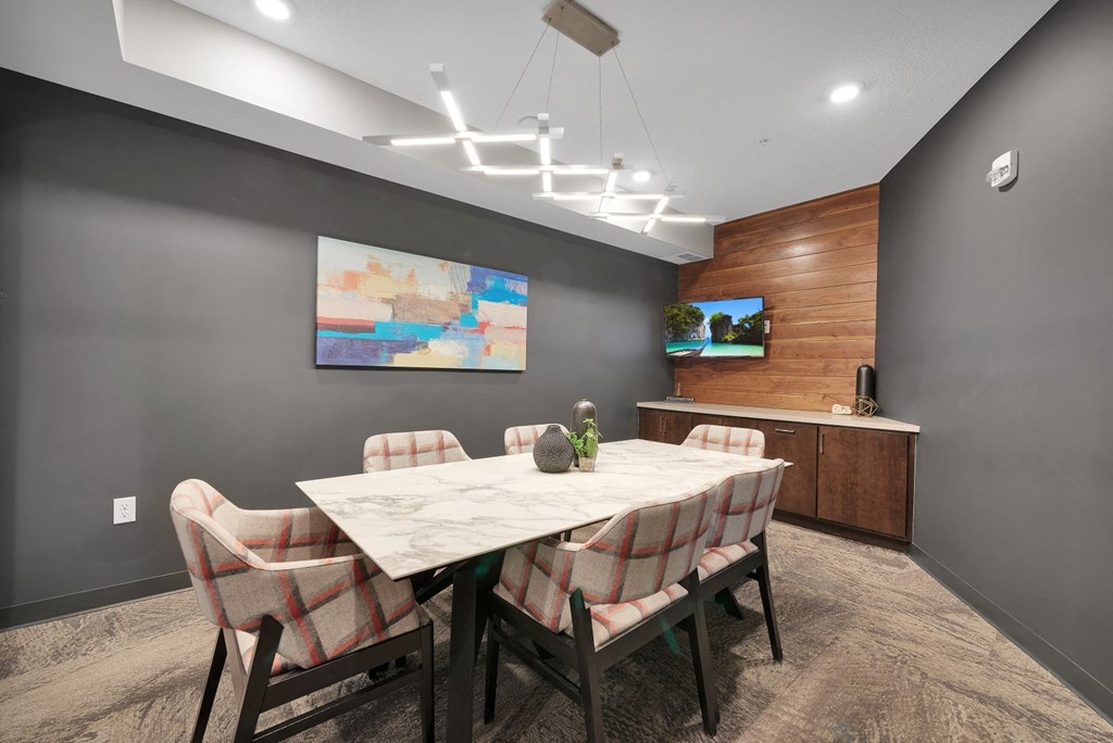 a dining room with a marble table and chairs