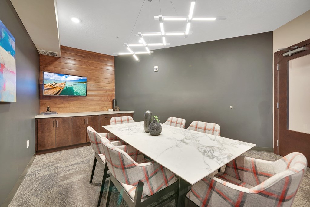 a dining room with a marble table and chairs