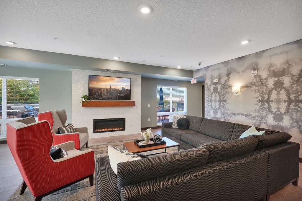 a living room with couches and chairs and a fireplace