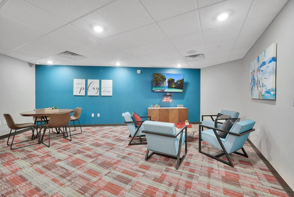 a conference room with a blue wall and a table and chairs