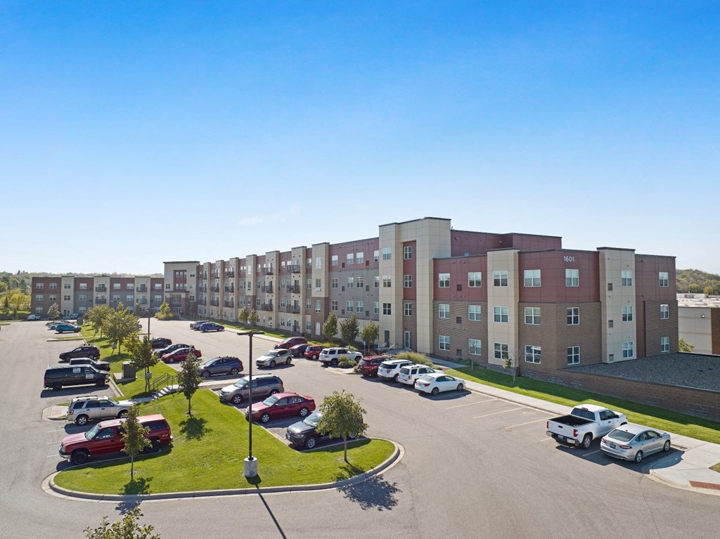 a parking lot in front of an apartment building