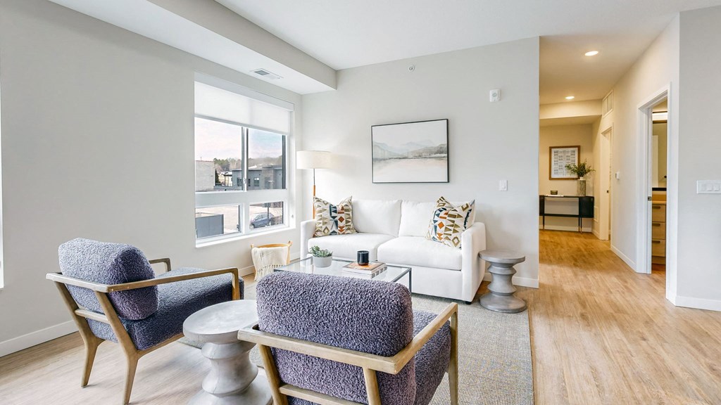 a living room with a couch and chairs and a table