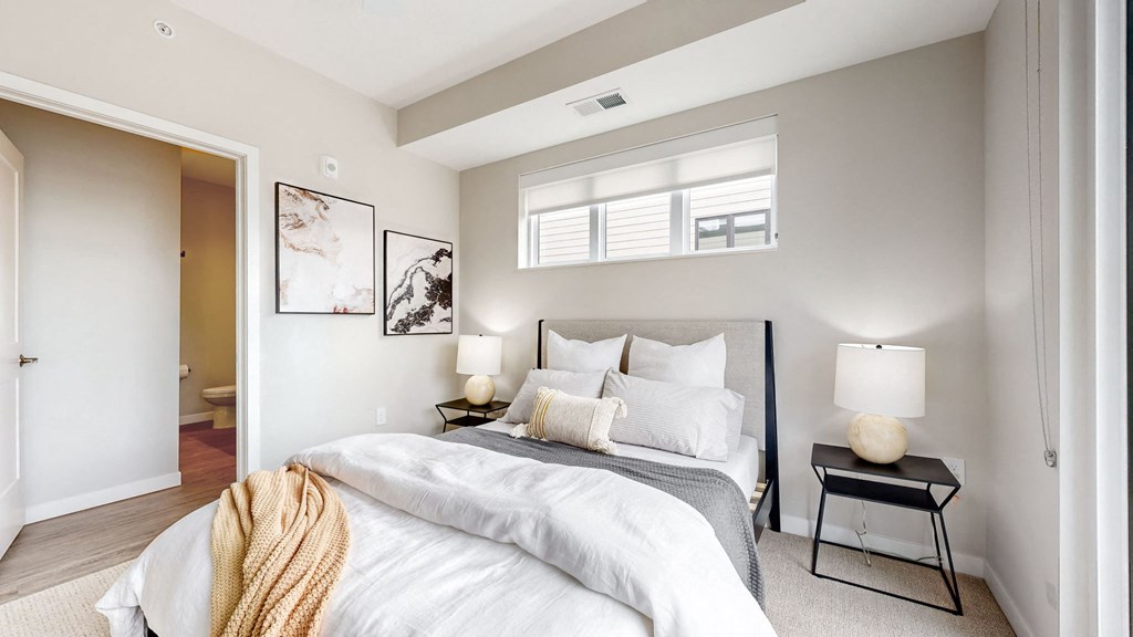 a bedroom with a large bed and a window