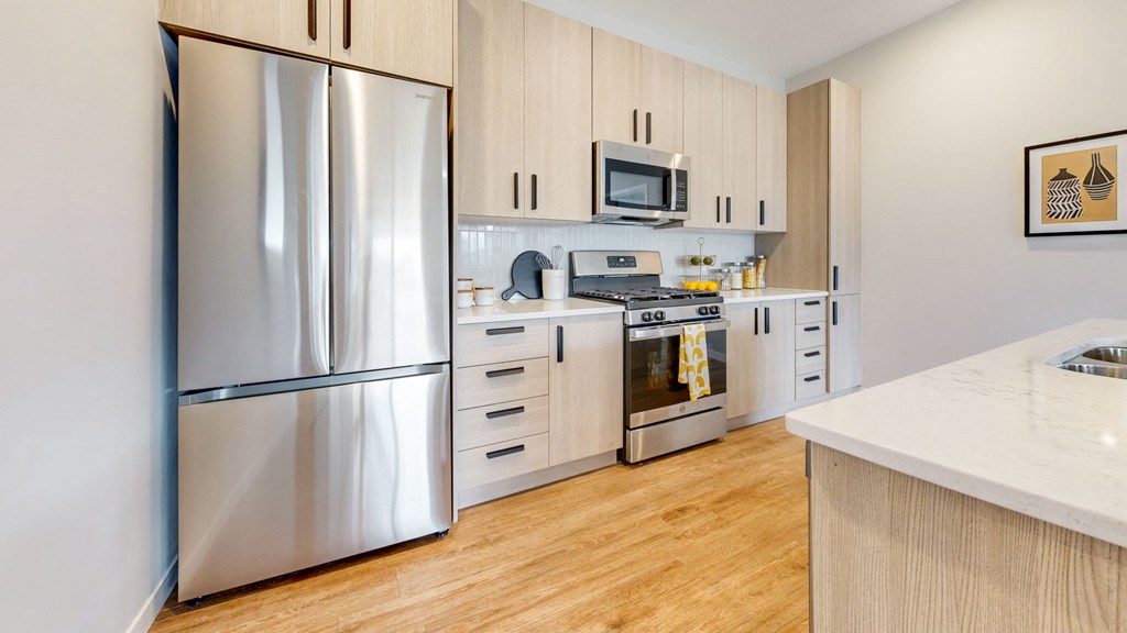 a kitchen with stainless steel appliances and white cabinets