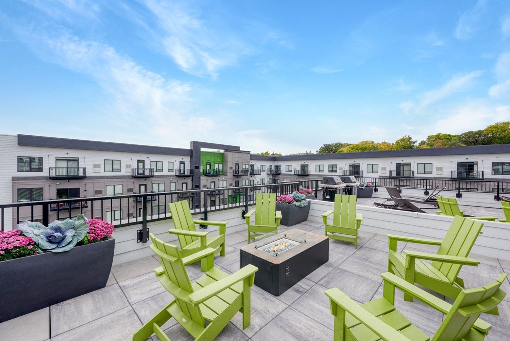 a rooftop patio with green chairs and patio furniture at The Yards and Backyards, South St. Paul, Minnesota