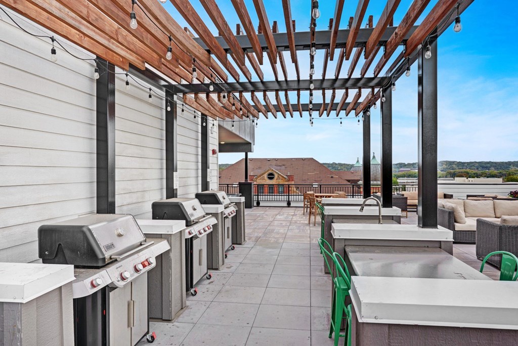 the outlook of the rooftop patio with barbecue grills and a pergola at The Yards and Backyards, Minnesota