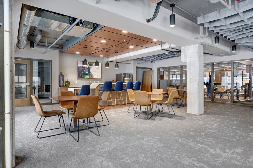a communal area with tables and chairs in a lobby