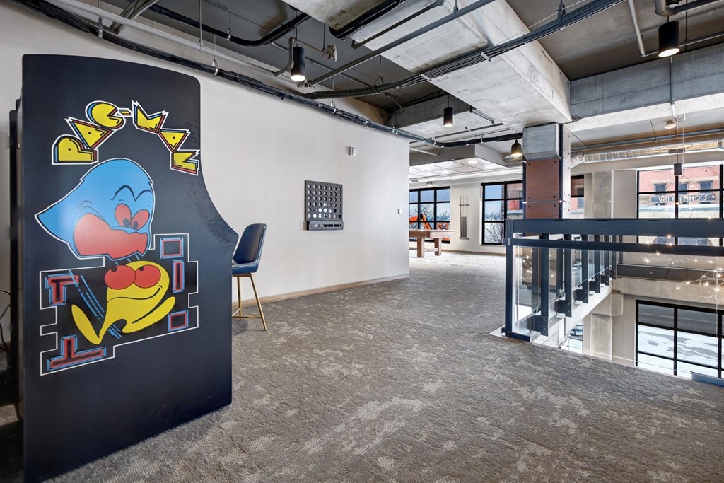 Pac Man game in a room with a staircase in the at The Yards and Backyards, MN 55075
