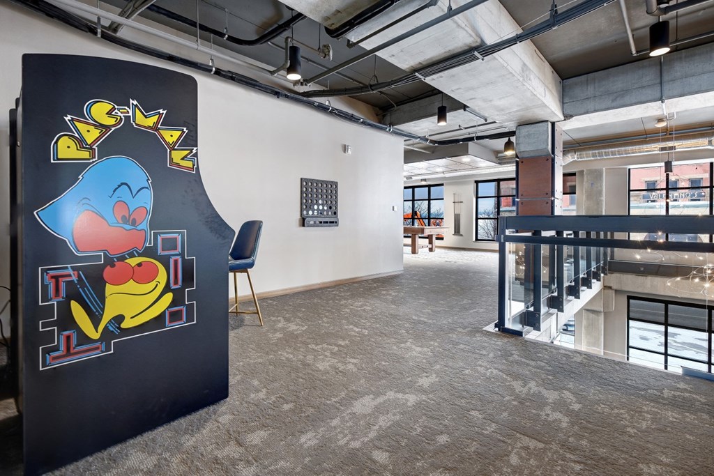 a mural of a cartoon character on a video game machiene in a room with a staircase in the