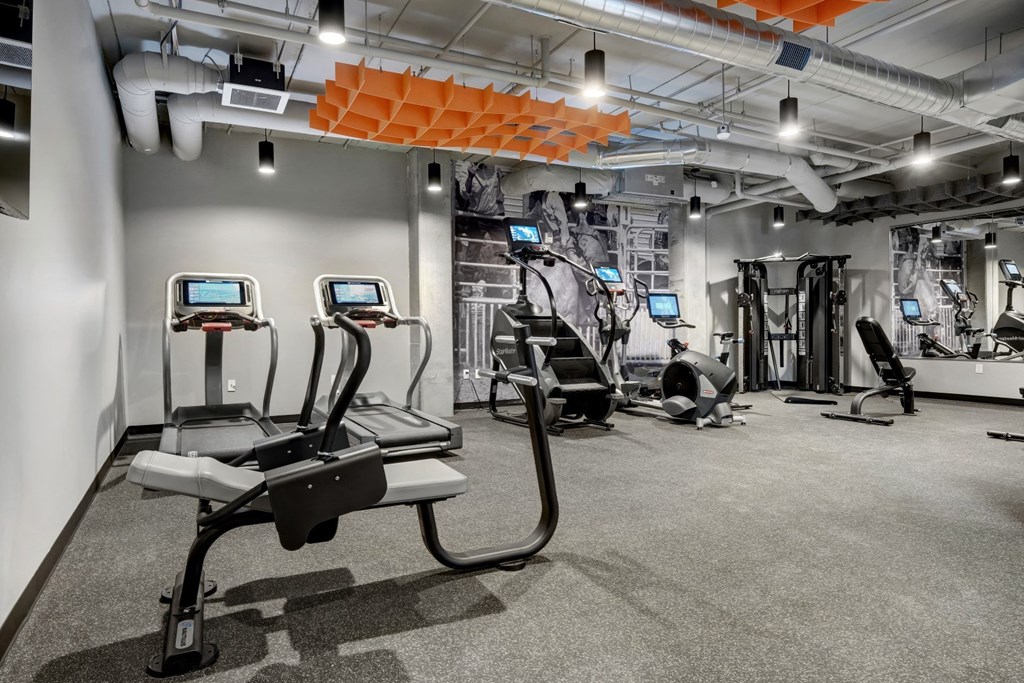 a gym with treadmills and other exercise equipment in a building