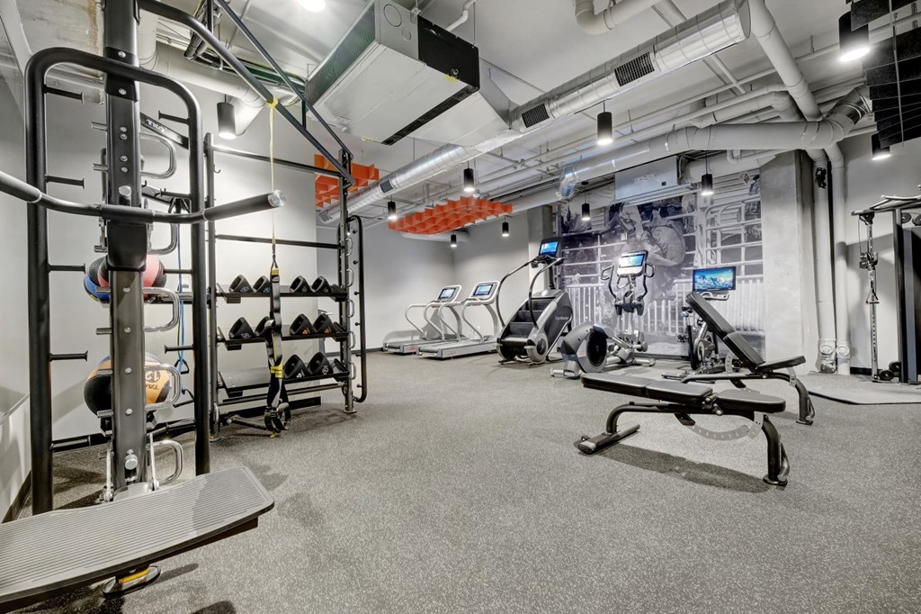 fitness center with black rubber floors, strentgth and cardio equipment