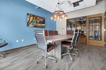 a conference room with a large table and chairs