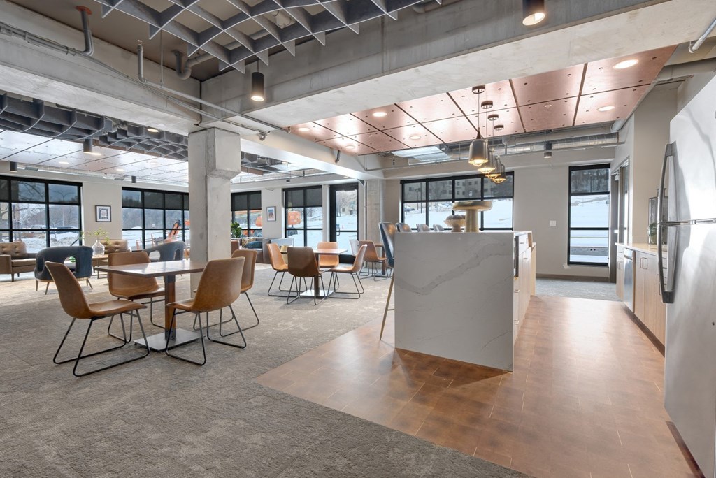 a large room with tables and chairs and a counter