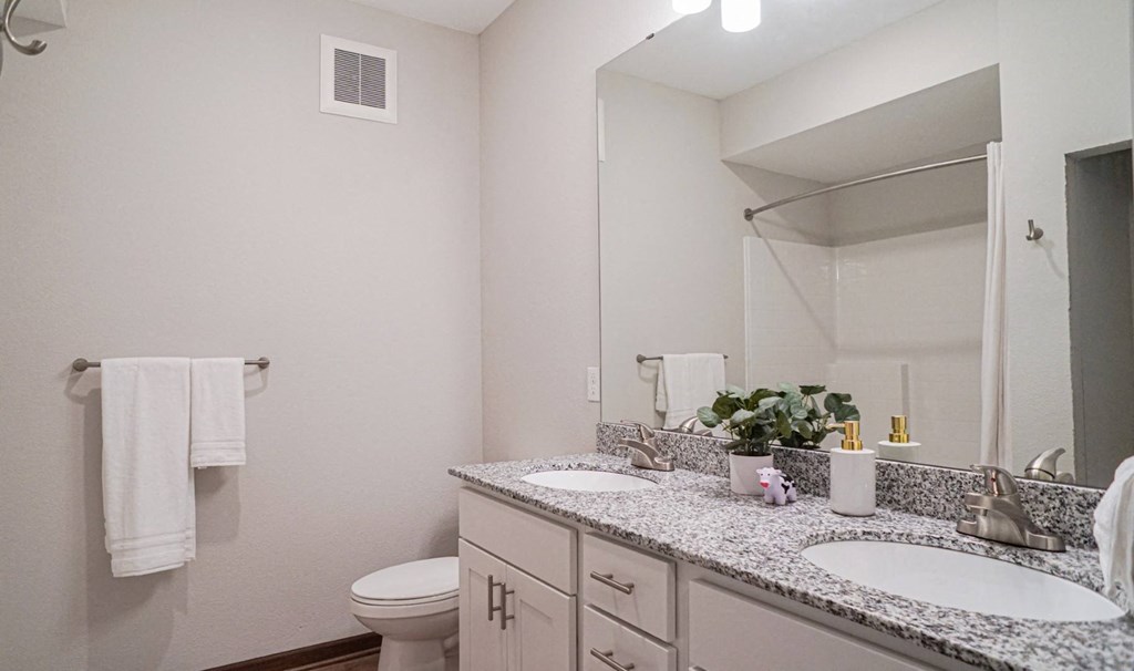 a bathroom with two sinks and a toilet at The Yards and Backyards, Minnesota