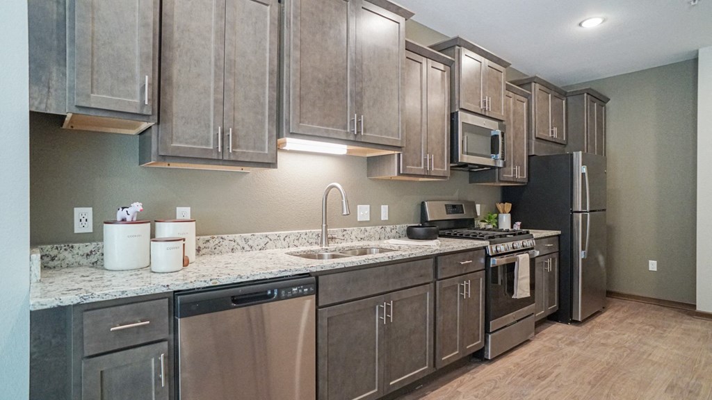 a kitchen with stainless steel appliances and granite counter tops