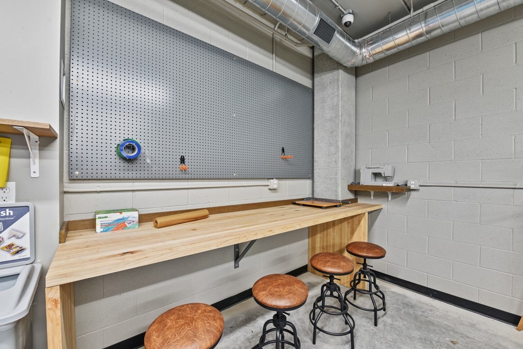 a bar with four stools in a room with a counter