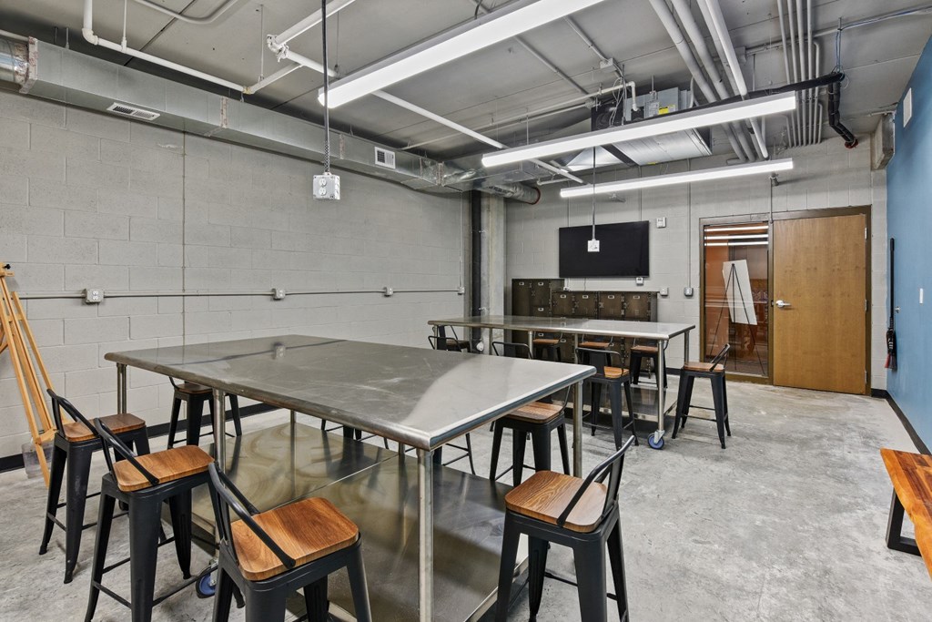 a large room with tables and chairs and a projection screen