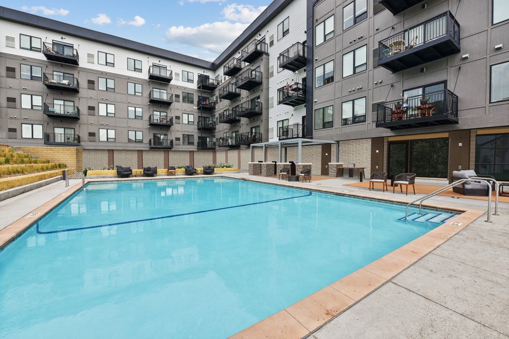 a swimming pool in front of an apartment building