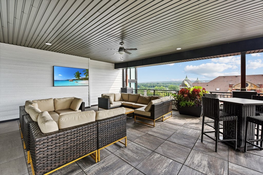 a patio with couches and chairs and a table and chairs