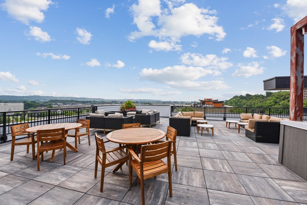 a rooftop patio with tables and chairs