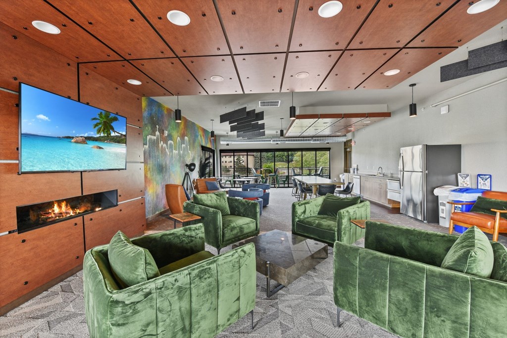 a living room with green couches and chairs and a fireplace