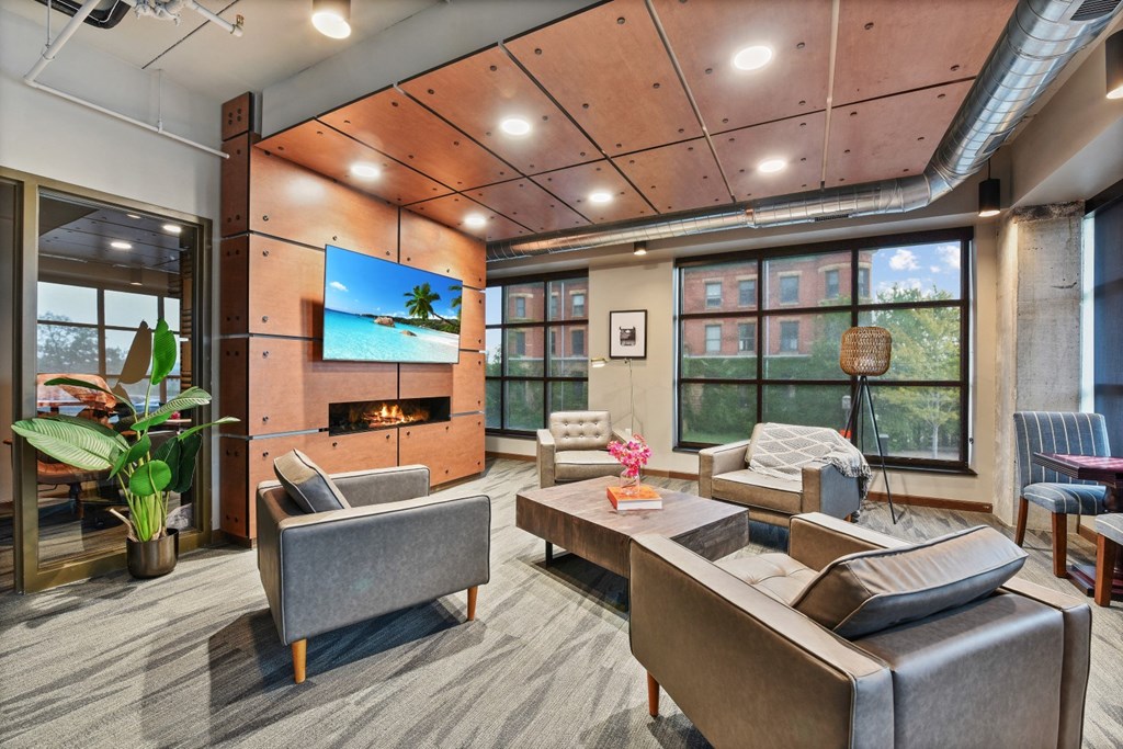 a living room with couches and chairs and a tv