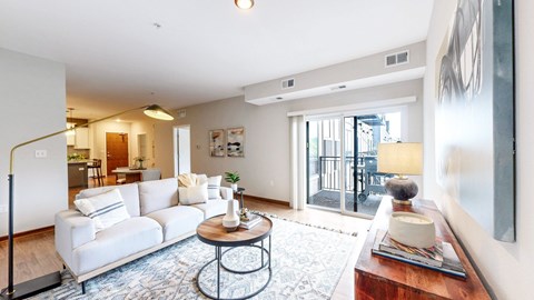 A living room with a white sofa and a coffee table.