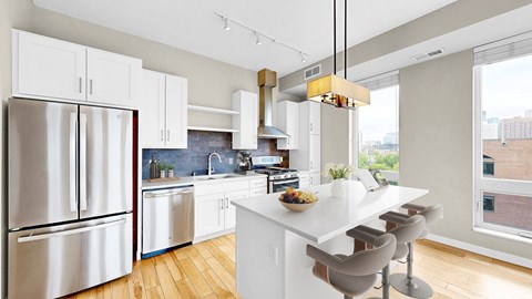 A modern kitchen with a white island and stainless steel appliances.