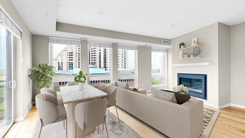 A modern living room with a fireplace and a dining table set up.